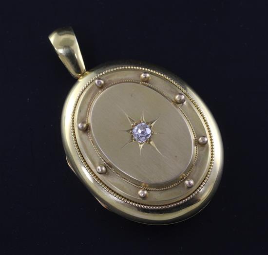A Victorian 15ct gold and diamond set oval locket, 1.75in.